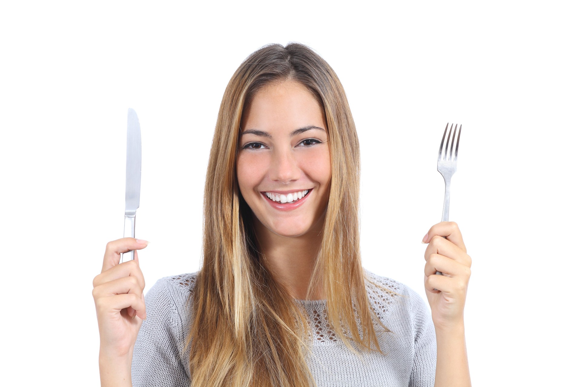 Beautiful woman holding a fork and table knife